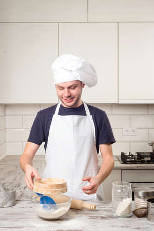 Portrait of a male chef cook preparation pastry on a kitchenの写真素材