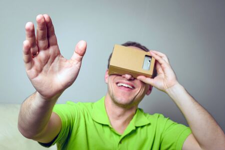 Concept of virtual reality carton glasses and interfaces. man enjoying vr glasses.