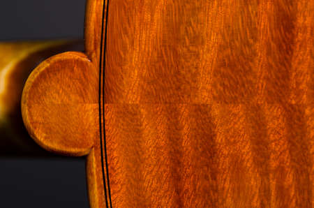 wooden violin part on black background, macroの写真素材