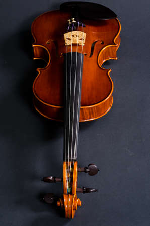 view of old wooden violin on black backgroundの写真素材