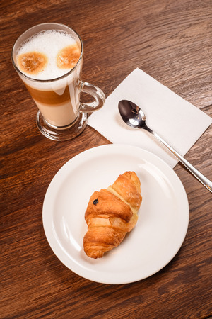 breakfast with cup coffee and croissant in bakeryの写真素材
