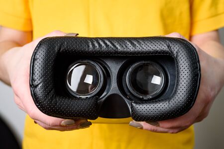 Virtual reality concept. Man or women holding VR glasses device in Handの写真素材