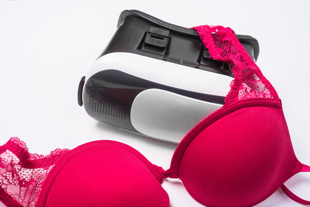 Virtual reality glasses for mobile devices with women lingerie and bra on white background. VR concept, used for porn video in adult entertainmentの写真素材