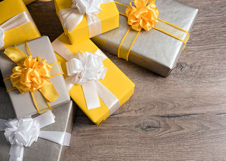 pile of yellow and grey Christmas giftsの写真素材