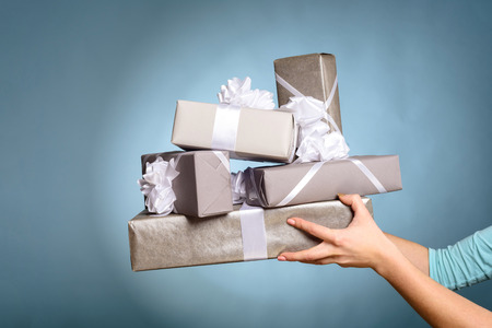 Hands holding gift box with as a present for Christmasの写真素材