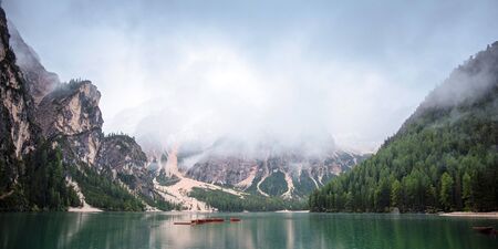 Braies lake and boats in mountain in Dolomitesの写真素材
