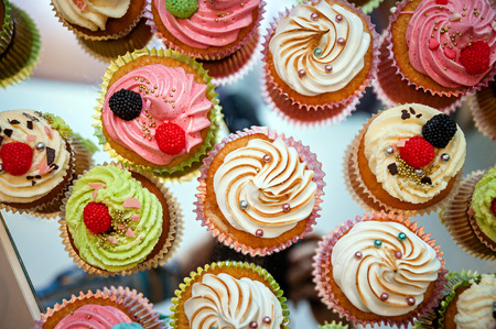 Tasty cupcakes on a white wooden tableの写真素材