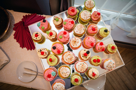 Tasty cupcakes on a white wooden tableの写真素材