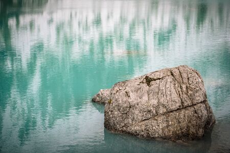 The mountain lake Lago di Sorapiss in Dolomite Alps. Italy, with amazing turquoise color of water.の写真素材