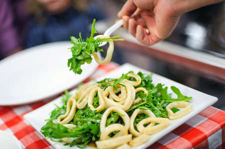 Squid salad on a plate on the tableの写真素材