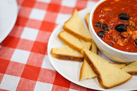 Tomato soup with tomatoes and olivesの写真素材