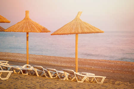 A straw umbrella on a beachの写真素材