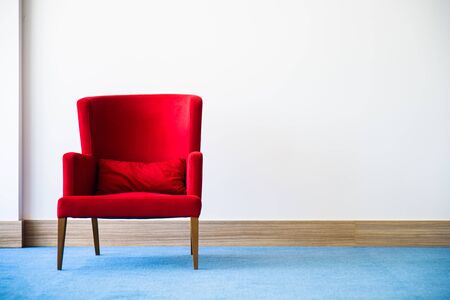 Red chair in white interiorの写真素材
