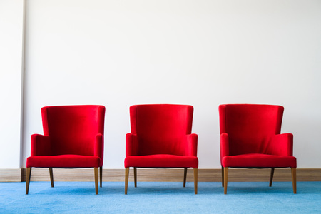 Red chair in white interiorの写真素材