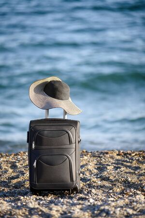 suitcase and hat on beachの写真素材