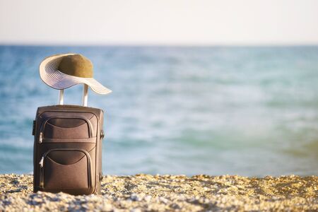 suitcase and hat on beachの写真素材