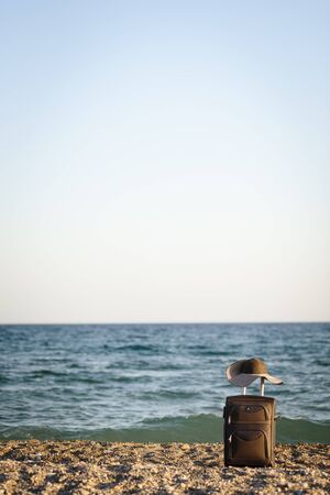 suitcase and hat on beachの写真素材