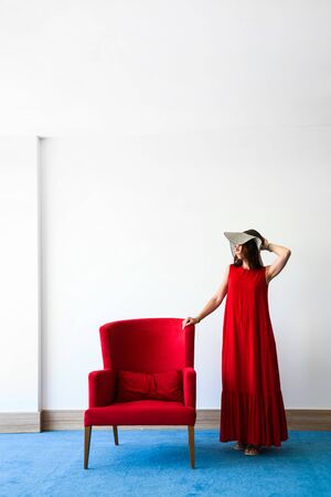 Beautiful young woman in red dressの写真素材