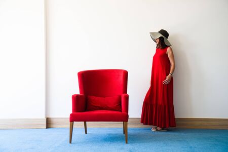 Beautiful young woman in red dressの写真素材