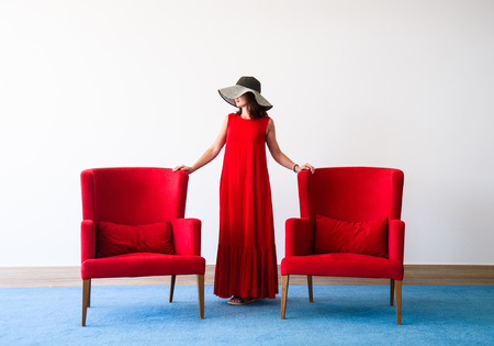 Beautiful young woman in red dressの写真素材