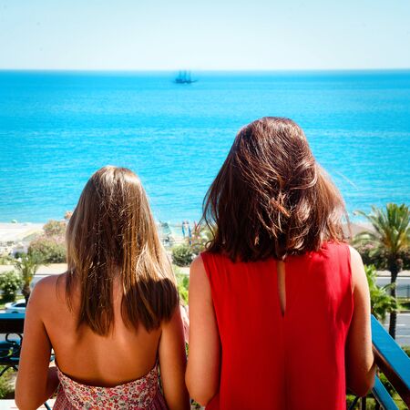 Mother and daughter on the seaの写真素材