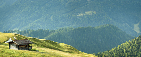 landscape with wooden house in Dolomites Aplの写真素材