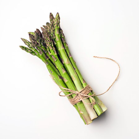 Food background asparagus flat lay pattern. bunch of fresh green asparagus on white background, top view.の写真素材