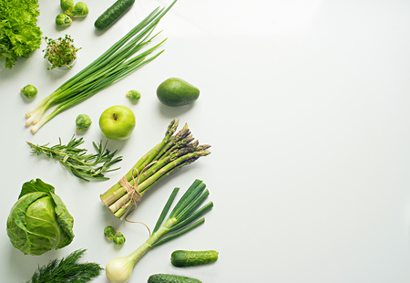 Green vegetables wide flat lay concept. Microgreens, brussels sprouts, asparagus, rosemary, avocado, onion, cabbage and cucumber on white background, top viewの写真素材