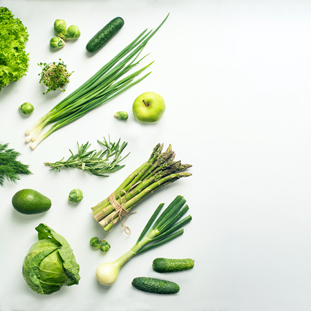 Green vegetables wide flat lay concept. Microgreens, brussels sprouts, asparagus, rosemary, avocado, onion, cabbage and cucumber on white background, top viewの写真素材