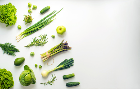Green vegetables wide flat lay concept. Microgreens, brussels sprouts, asparagus, rosemary, avocado, onion, cabbage and cucumber on white background, top viewの写真素材