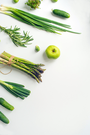 Green vegetables wide flat lay concept. Microgreens, brussels sprouts, asparagus, rosemary, avocado, onion, cabbage and cucumber on white background, top viewの写真素材