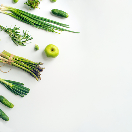 Green vegetables wide flat lay concept. Microgreens, brussels sprouts, asparagus, rosemary, avocado, onion, cabbage and cucumber on white background, top viewの写真素材