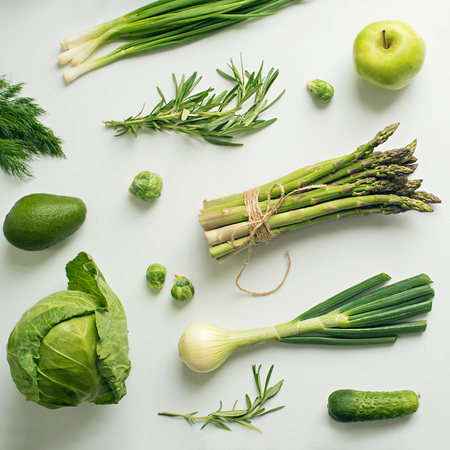 Green vegetables wide flat lay concept. Microgreens, brussels sprouts, asparagus, rosemary, avocado, onion, cabbage and cucumber on white background, top viewの写真素材