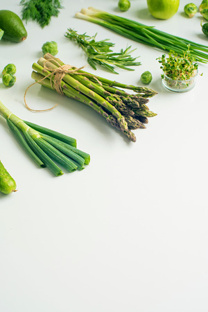 Green vegetables concept. Microgreens, brussels sprouts, asparagus, rosemary, avocado, onion, cabbage and cucumber on white background,の写真素材