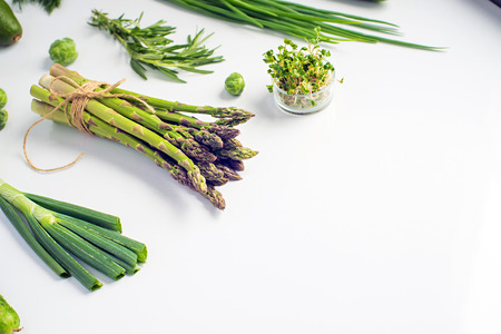Green vegetables concept. Microgreens, brussels sprouts, asparagus, rosemary, avocado, onion, cabbage and cucumber on white background,の写真素材