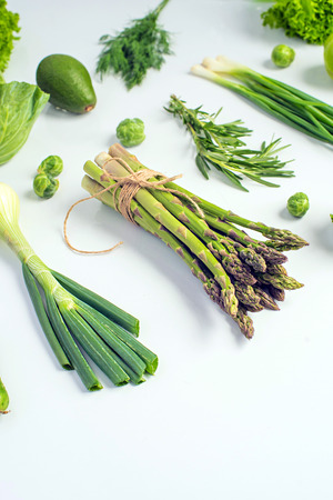 Green vegetables concept. Microgreens, brussels sprouts, asparagus, rosemary, avocado, onion, cabbage and cucumber on white background,の写真素材
