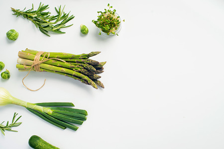 Green vegetables concept. Microgreens, brussels sprouts, asparagus, rosemary, avocado, onion, cabbage and cucumber on white background,の写真素材