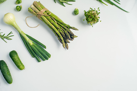 Green vegetables concept. Microgreens, brussels sprouts, asparagus, rosemary, avocado, onion, cabbage and cucumber on white background,の写真素材