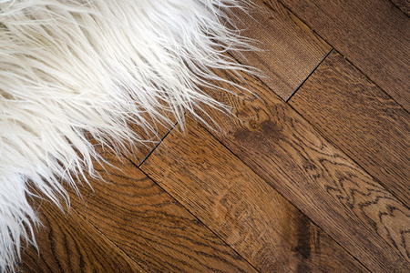 Decorative fur carpet on wood floorの写真素材