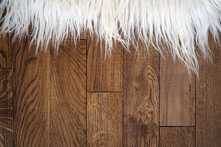 Decorative fur carpet on wood floorの写真素材