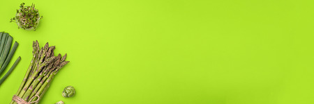 Green vegetables flat lay concept on green backgroundの写真素材