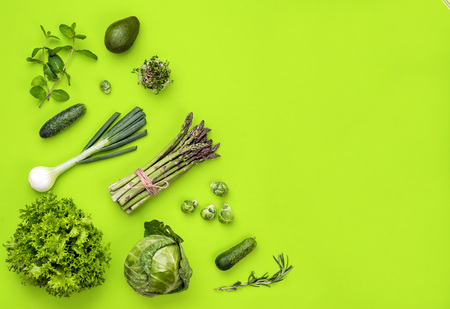 Green vegetables flat lay concept on green backgroundの写真素材