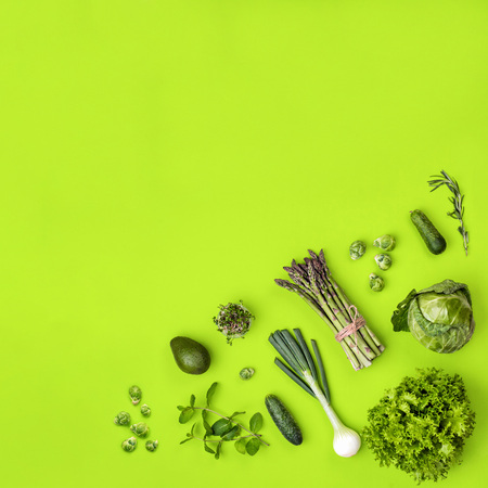 Green vegetables flat lay concept on green backgroundの写真素材