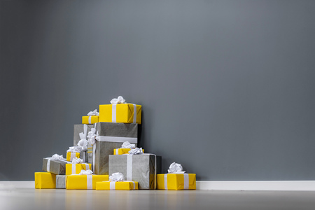 pile of yellow and grey Christmas giftsの写真素材
