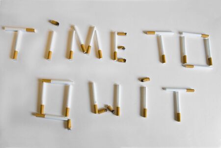 Slogan Time To Quit formed by cigarette tubes and butts の写真素材