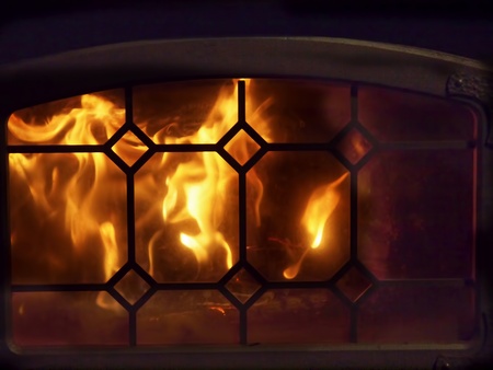 Fire blazing in the fireplace with decorative screenの写真素材