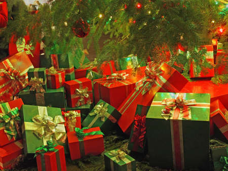 Christmas-themed wrapped gift boxes under the treeの写真素材