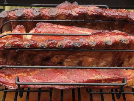 Portion of spareribs cooked on a charcoal smokerの写真素材