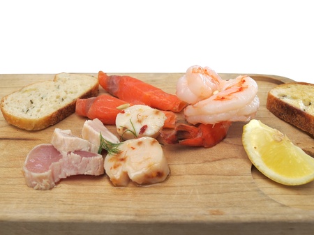 Seafood tasing board with lemon and toast in restaurantの写真素材