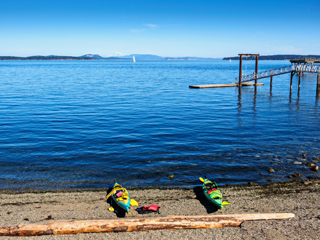Two kayaks on the Glass Beach with a view on Mt. Baker from Sidney, Vancouver Island, Canadaの写真素材